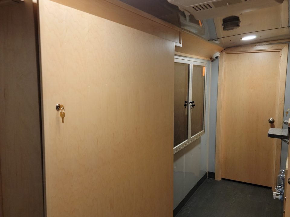 Interior corridor with maple cabinetry and the dispensing window
