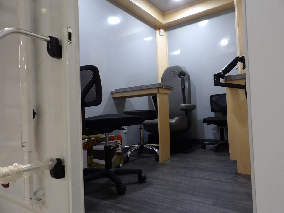 Counseling booths with desks and chairs inside the treatment unit