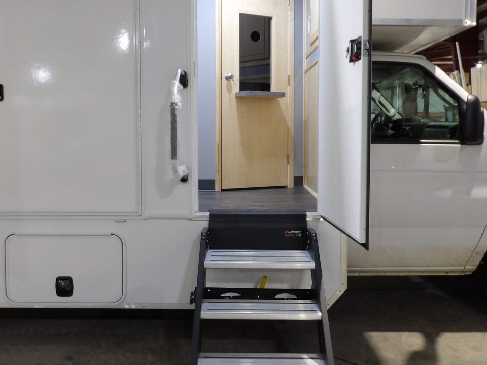 Entry door open with steps on the treatment unit