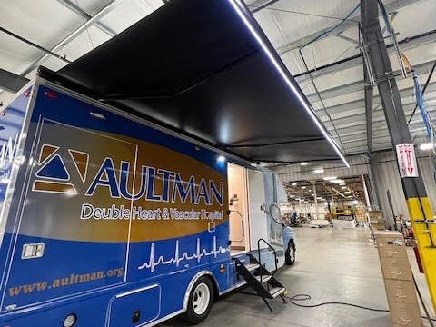 Mobile medical clinic with the awning out and entry door open