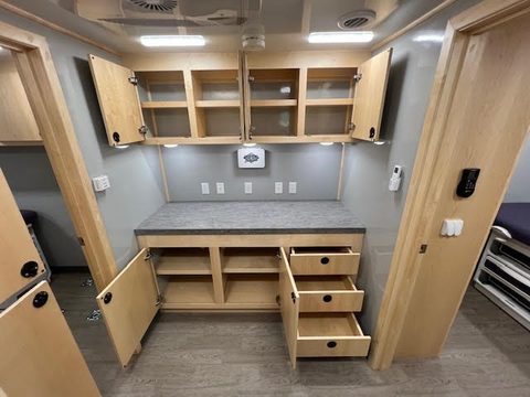 Counter with maple cabinets and drawers inside the clinic