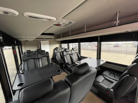 Bus interior looking aft, seating and tables both sides