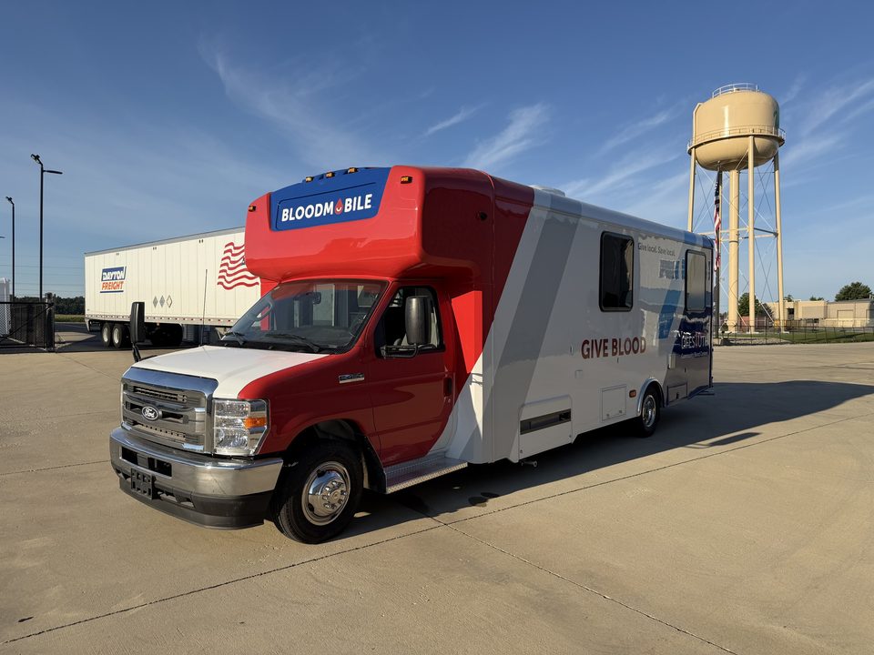 Bloodmobile outside the HLE plant with the Wakarusa water tower behind