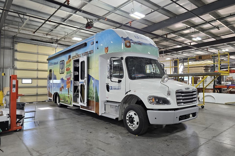 Bookmobile on a Freightliner M2, front three-quarter, in the HLE plant