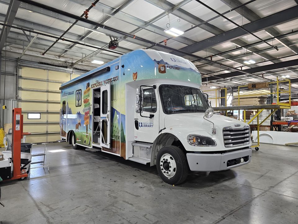 Bookmobile on a Freightliner M2, front three-quarter, in the HLE plant