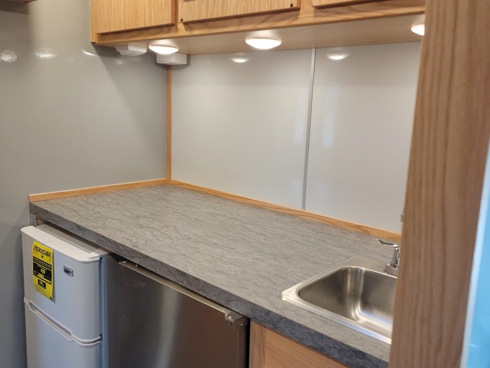 Counter with sink, refrigerator and oak cabinets