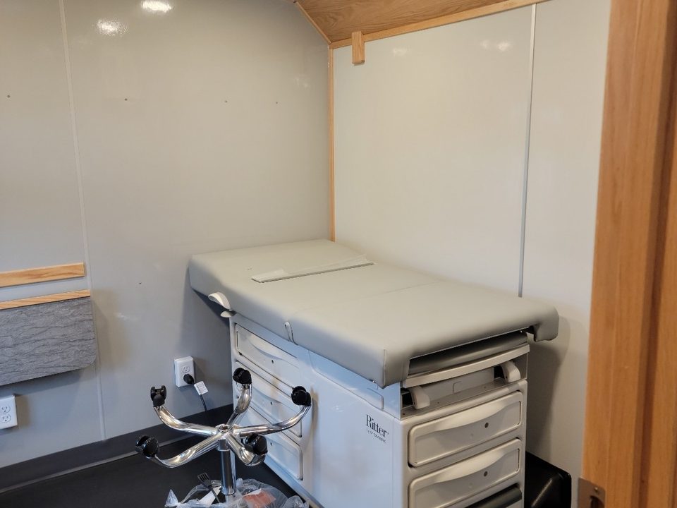 Exam table with drawer base inside the Wellness Wagon