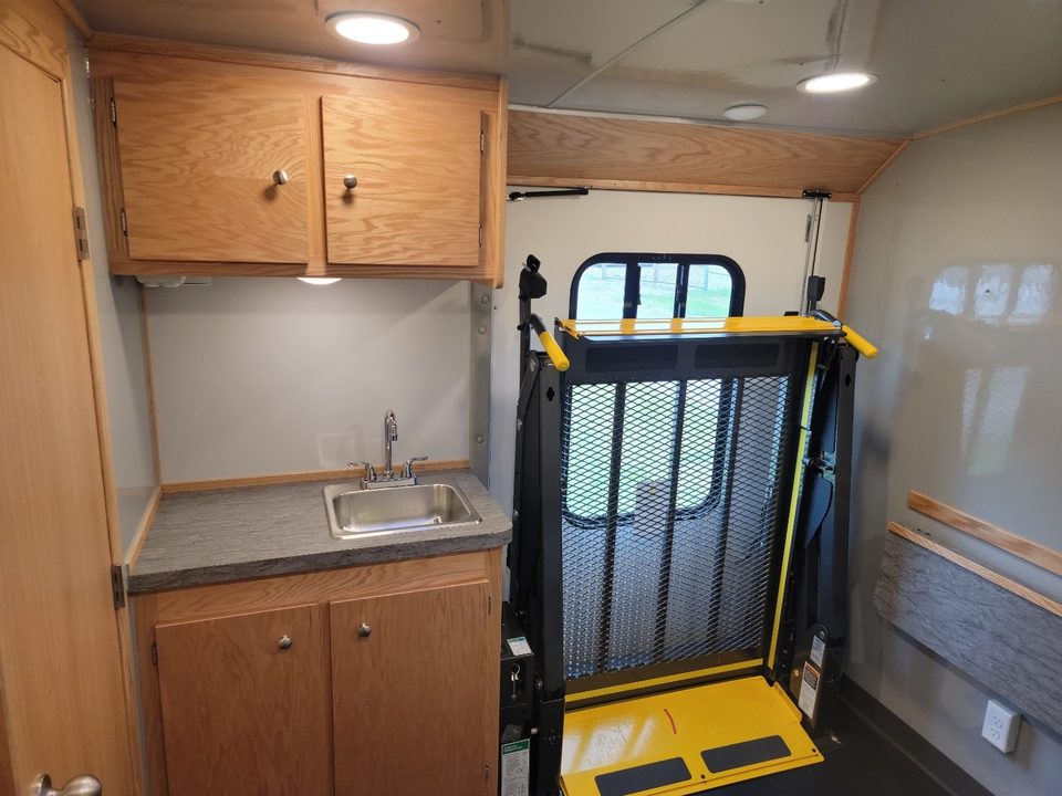 Sink counter and wheelchair lift inside the Wellness Wagon