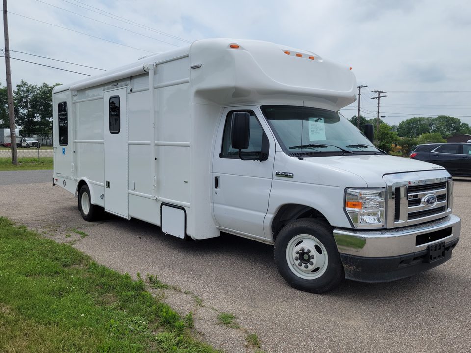 The same unit before graphics, white Ford E-450 cutaway, front three-quarter