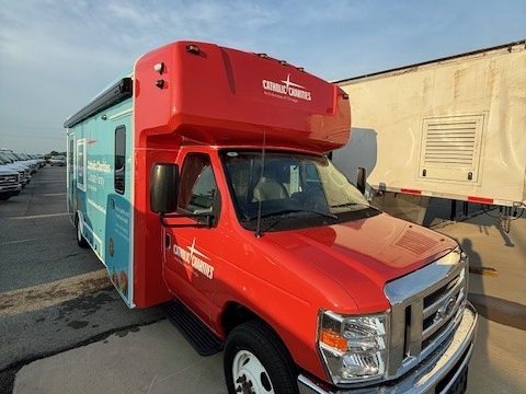 Mobile food pantry, front three-quarter, red Ford cab