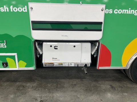 Onan generator compartment open on the side of the mobile market