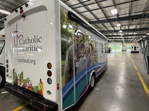 Mobile food pantry, rear three-quarter, wrap with a produce graphic