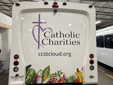 Mobile food pantry, rear, Catholic Charities lettering