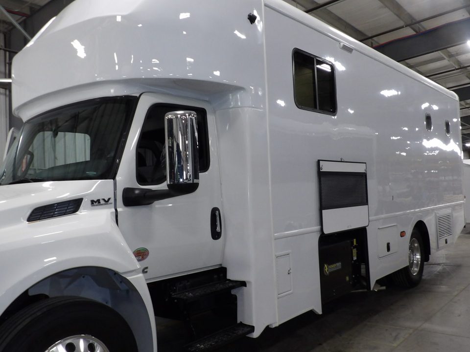 White mobile mammography unit on an International MV, front three-quarter, in the HLE plant