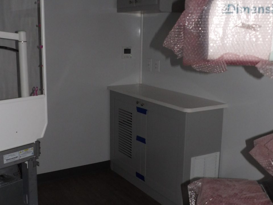 Mammography exam room with cabinets and wood-look floor