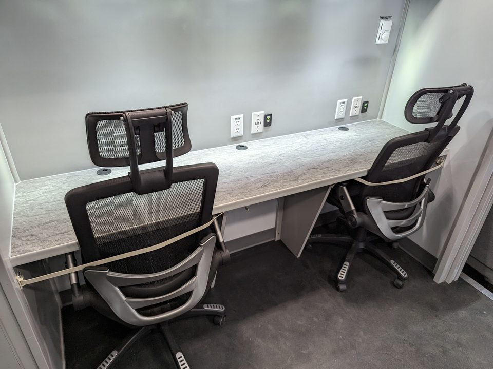 Command unit interior: two workstations with monitors and chairs