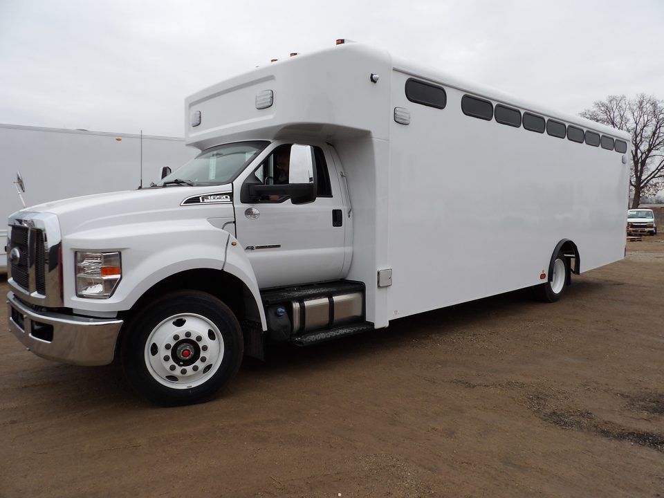White prisoner transport bus on a Ford F-650, front three-quarter, outside