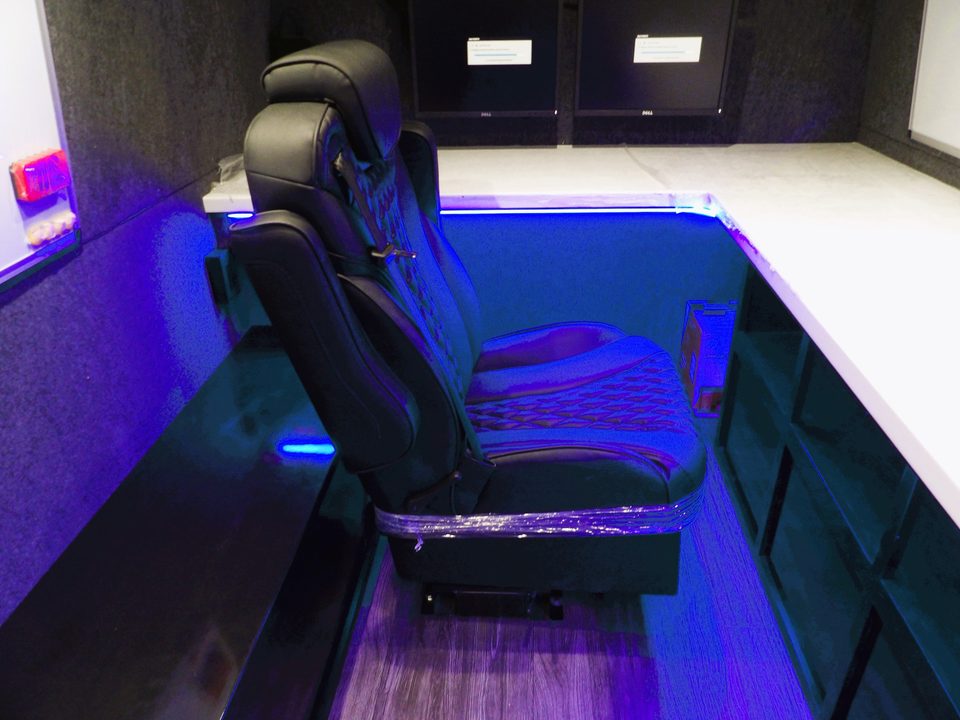 Quilted captain chair at the workstation under blue LED lighting