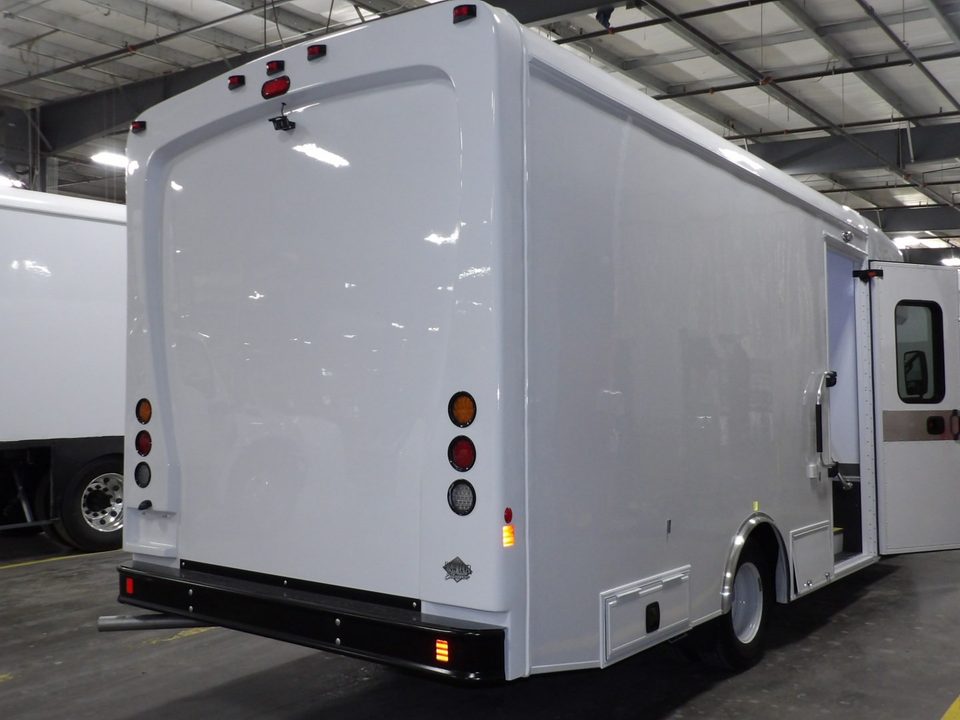 Mobile classroom, rear three-quarter, in the plant