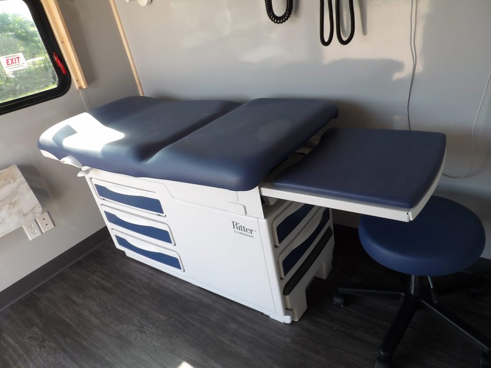 Exam table and drawer unit inside a mobile medical unit