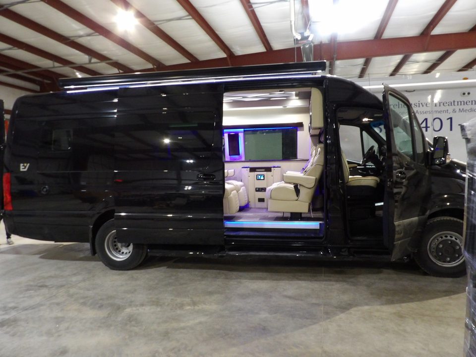 Black Mercedes-Benz Sprinter executive van, side door open, in the HLE plant