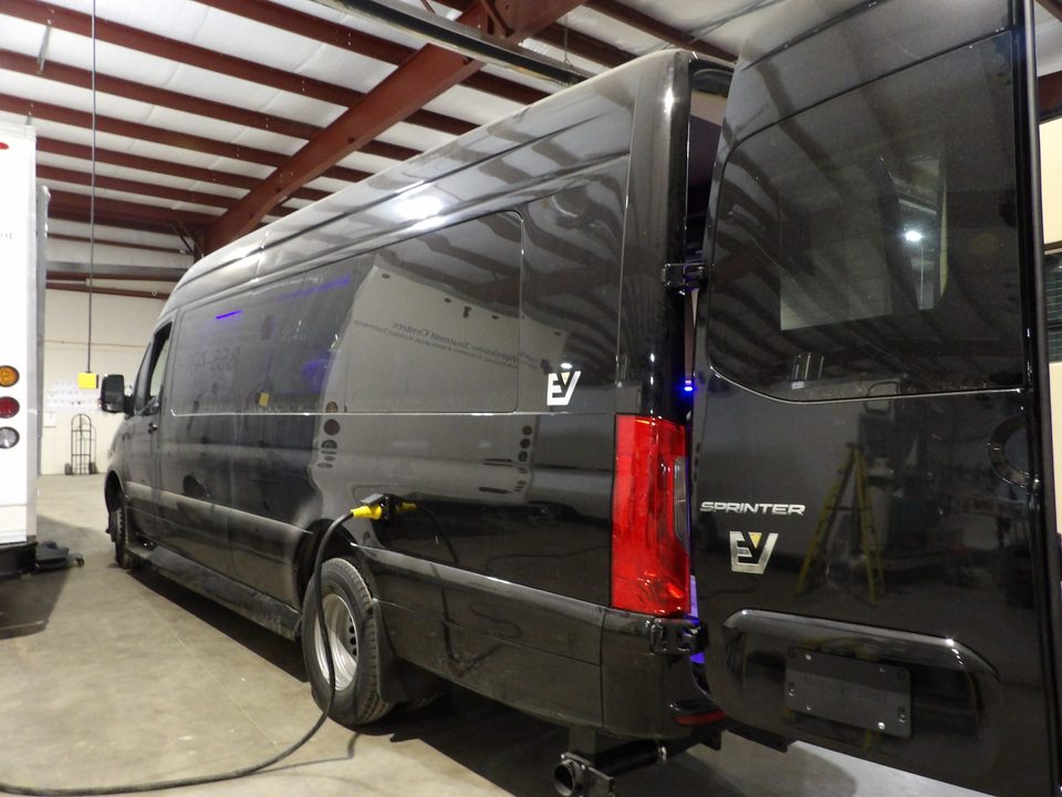 Black Sprinter executive van, rear three-quarter