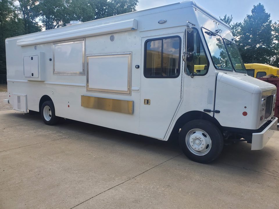 White mobile kitchen on a step van, front three-quarter, before graphics
