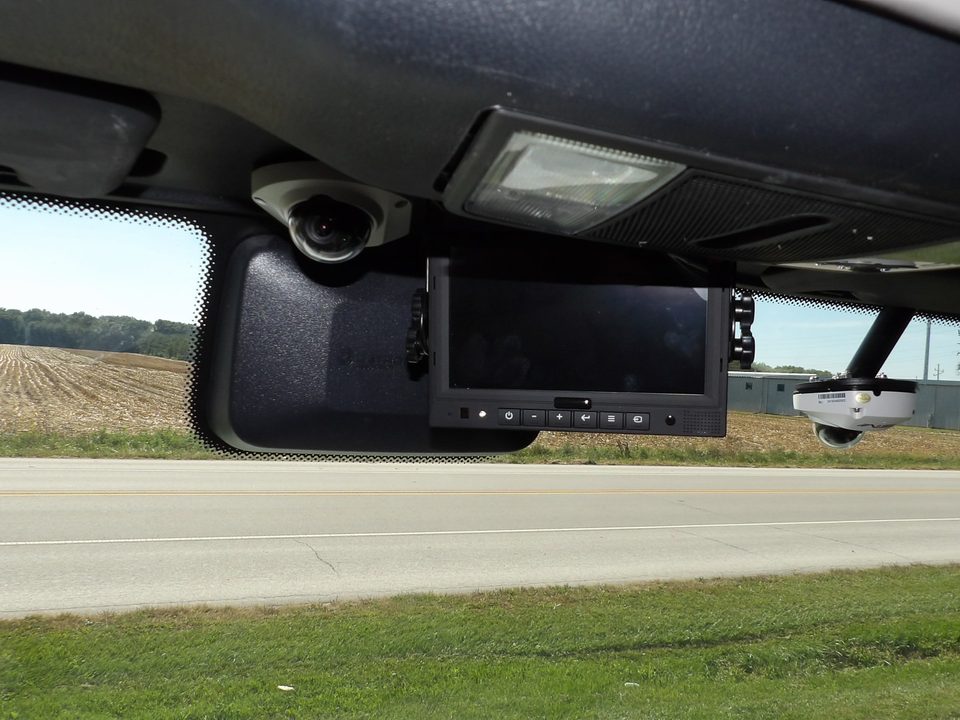 Camera monitor and dome camera mounted over the windshield in the cab