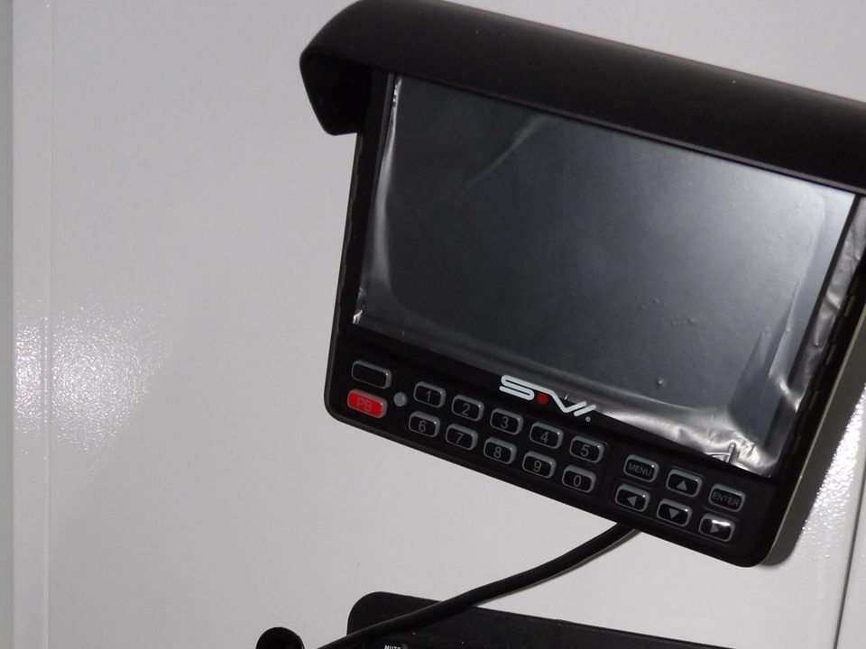 Officer station: camera monitor, radio and switch panel on the wall