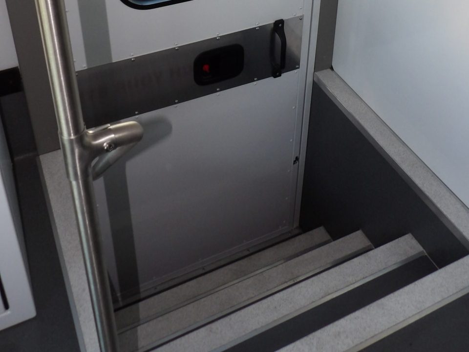 Entry stairwell with grab rail and windowed door