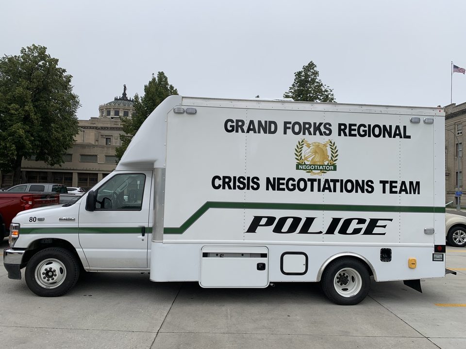 Crisis negotiations unit on a Ford E-450 cutaway, lettered Grand Forks Regional Crisis Negotiations Team Police, driver side
