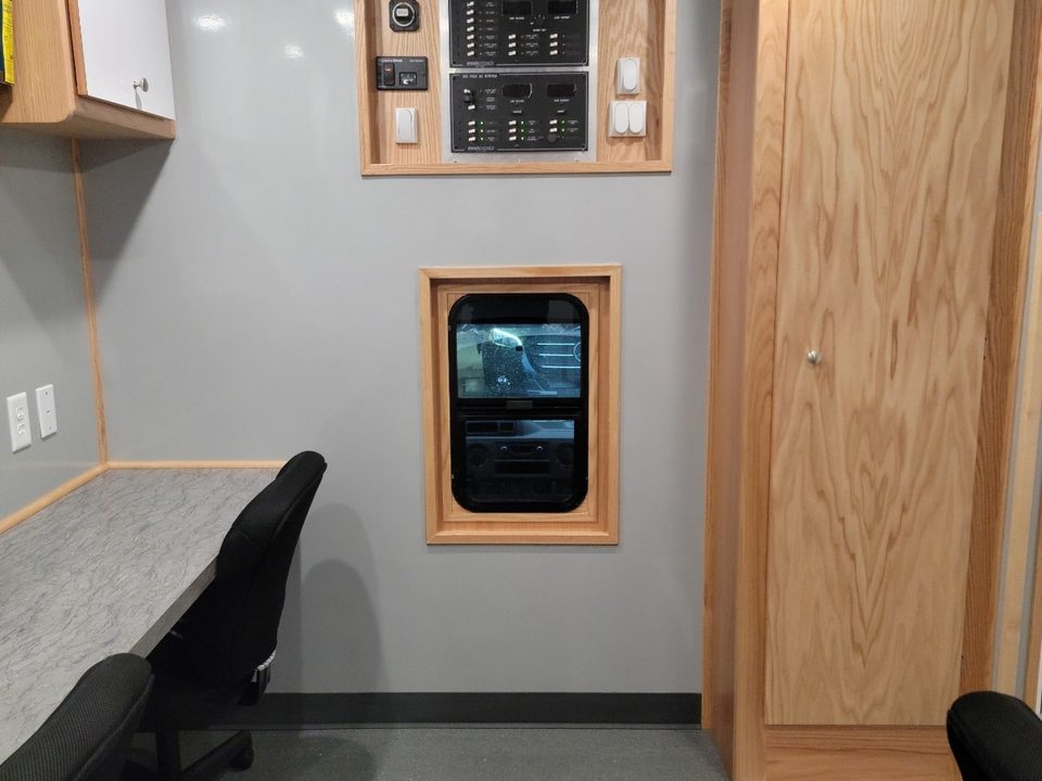 Workstation with task chair, switch panel and oak cabinets