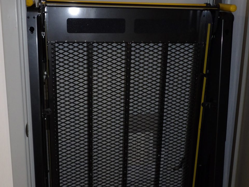 Wheelchair lift stowed inside the mammography unit door
