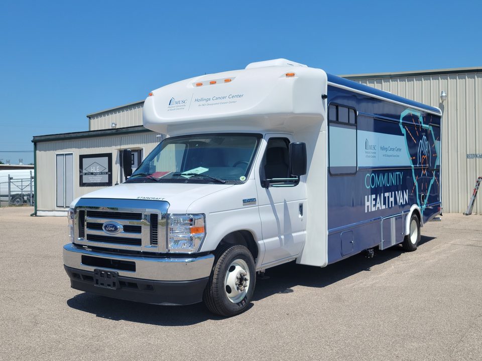 Community Health Van on a Ford E-450 cutaway, navy wrap, front three-quarter, outside