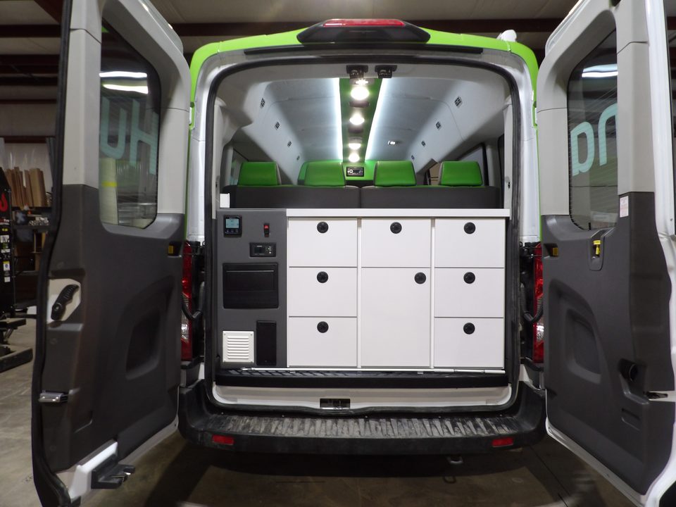 Rear doors open showing white storage cabinets