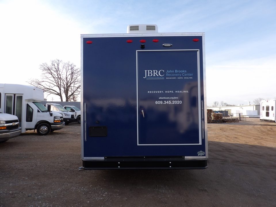 Mobile recovery unit, rear, wrapped navy with the rear door