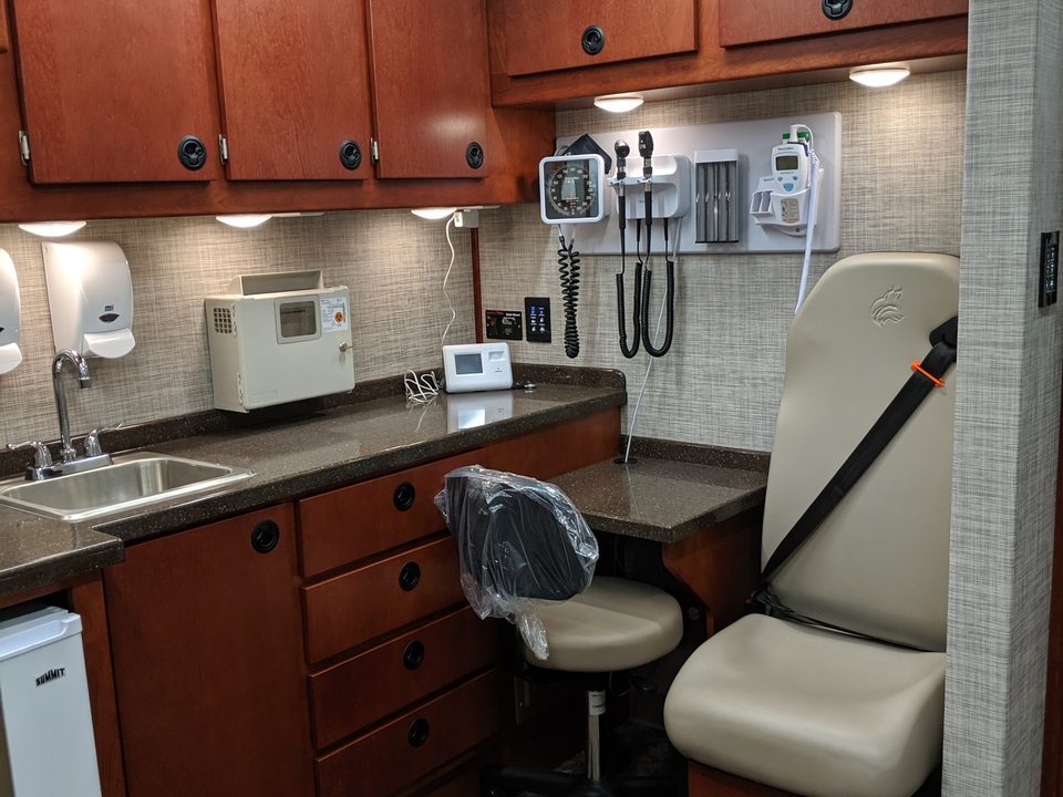 Exam room with cherry cabinetry and diagnostic set