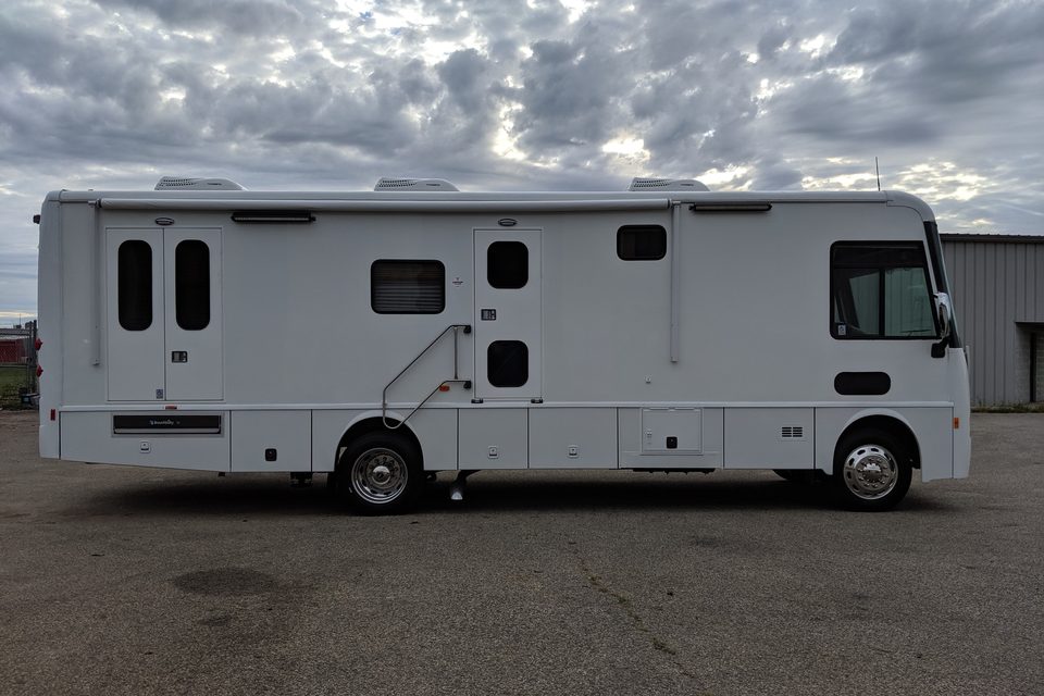 White mobile medical unit on a Freightliner chassis, side