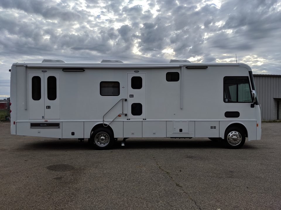White mobile medical unit on a Freightliner chassis, side