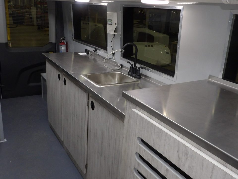 Stainless work counters and sink inside the lab van
