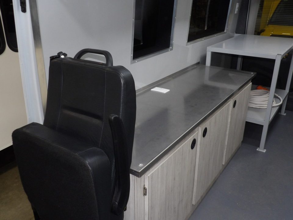 Lab van interior: seat, counter and stainless work table