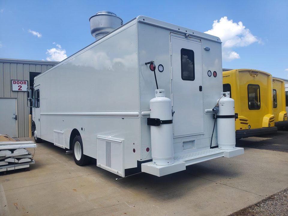 Mobile kitchen on a step van, white, with propane cabinet and serving window