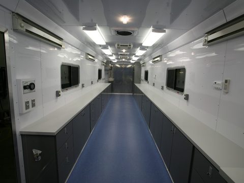 Gooseneck trailer interior: work counters both sides, cabinets