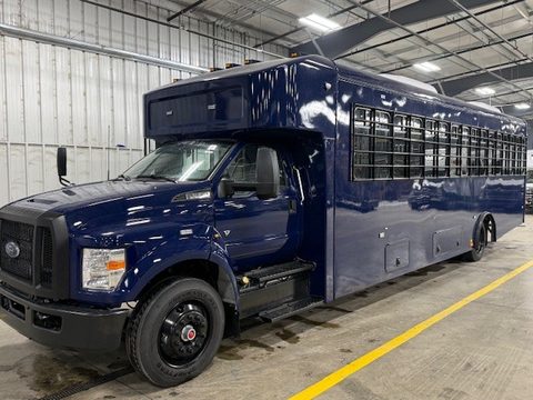 Navy prisoner transport bus on a Ford F-650, front three-quarter, in the HLE plant