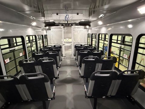 Interior looking forward: molded seats both sides, mesh partition