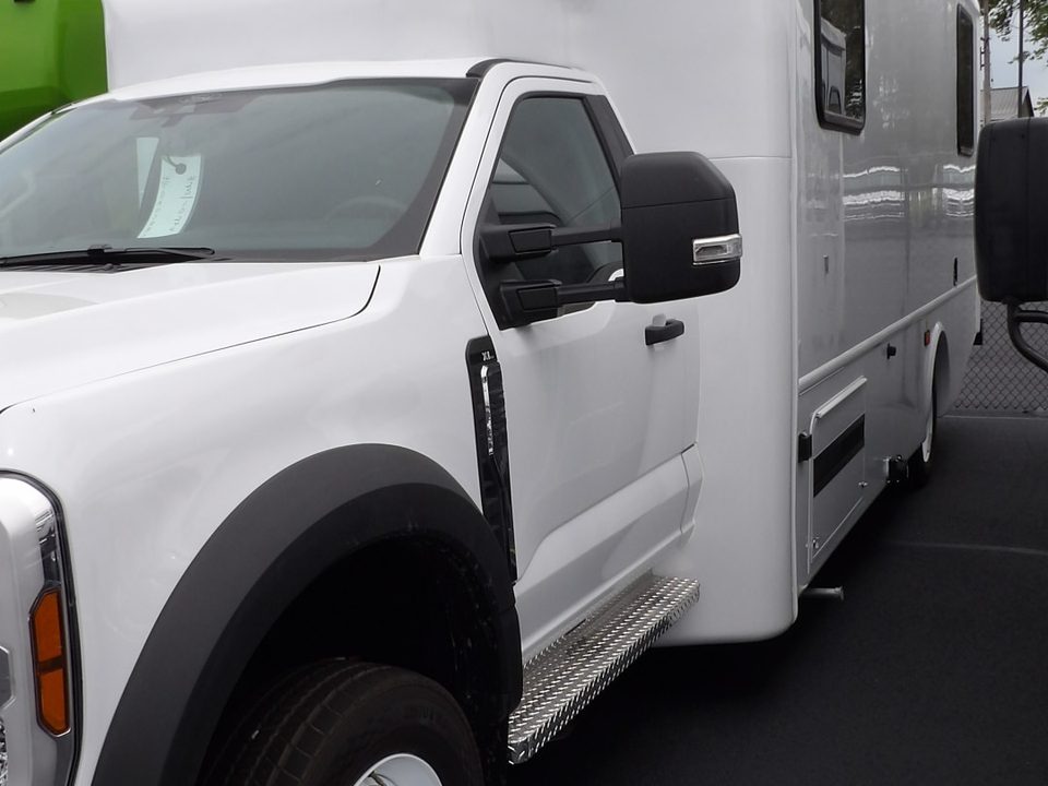 White mobile outreach unit on a Ford F-550, front three-quarter
