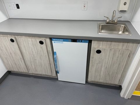 Counter with sink, refrigerator and cabinets