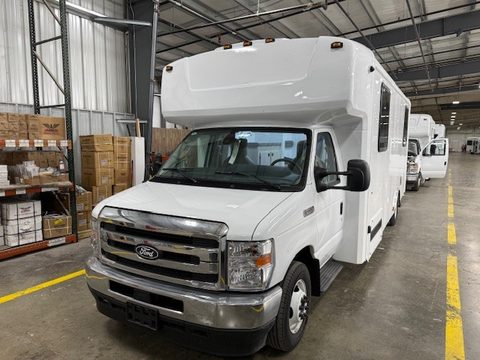 White mobile dental unit on a Ford E-450 cutaway, front three-quarter, in the HLE plant