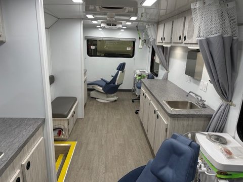 Dental unit interior looking aft: two operatories, privacy curtains, sink counters