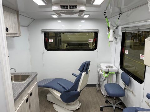 Dental operatory: blue dental chair, delivery unit, sink counter
